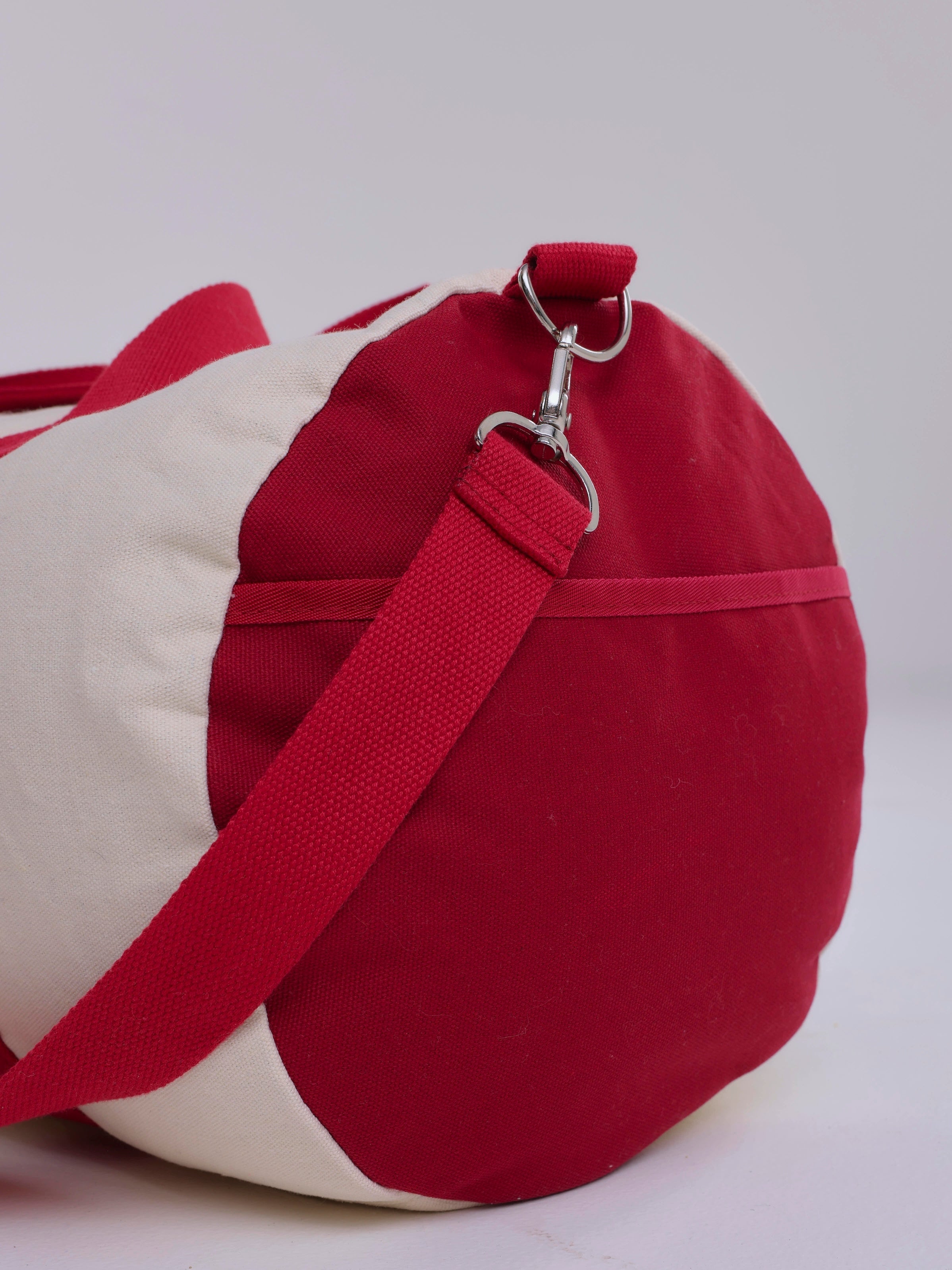 Red and beige bag with a strap on a white background